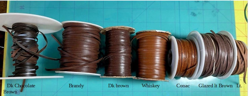 May include: Six spools of leather cord in various shades of brown, including Dark Chocolate Brown, Brandy, Dark Brown, Whiskey, Cognac, and Glazed Light Brown.
