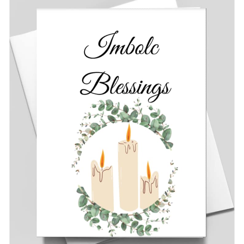 May include: A greeting card with the text "Imbolc Blessings" in black cursive font. The card features a wreath of green eucalyptus leaves with three white candles in the center.