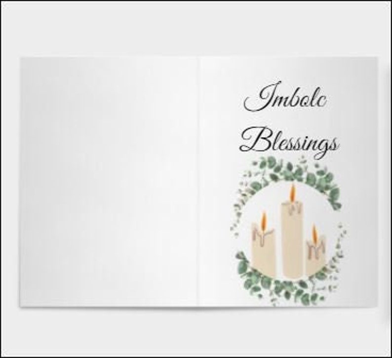 May include: A greeting card with a white background and the text "Imbolc Blessings" in black cursive script. The card features a wreath of eucalyptus leaves with three white candles in the center. The candles are lit and have melted wax dripping down the sides.