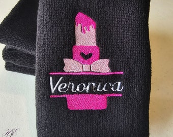 May include: Black washcloth with pink and white embroidery of a lipstick with the name Veronica.