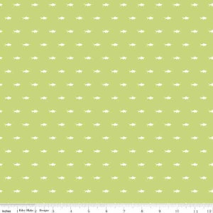 May include: A green fabric with a white repeating pattern of small fish. The fabric is 12 inches wide.
