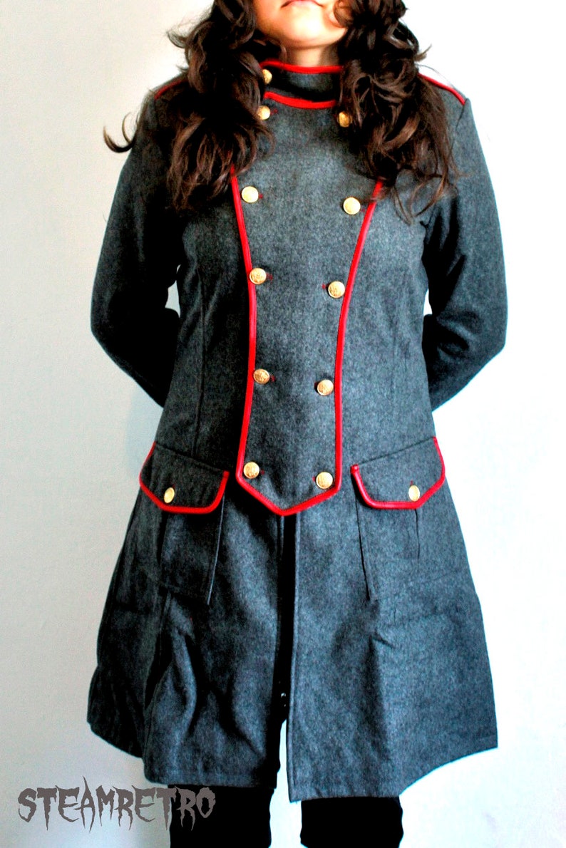 May include: A gray wool jacket with red trim and gold buttons. The jacket has a double-breasted closure and a high collar.