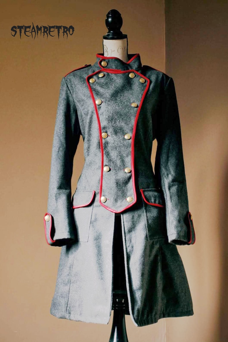 May include: A gray double-breasted coat with red trim and gold buttons. The coat has a long, flowing skirt and is cinched at the waist.