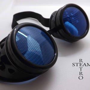 May include: Black steampunk goggles with blue mesh lenses. The goggles have a black leather strap and are designed with a retro aesthetic.