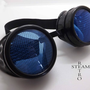 May include: Black steampunk goggles with blue mesh lenses. The goggles have a black elastic strap and are labeled "STEAM TRO".