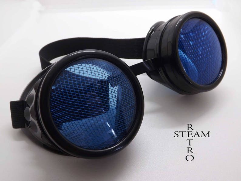 May include: Black steampunk goggles with blue mesh lenses. The goggles have a black elastic strap and are labeled "STEAM TRO".