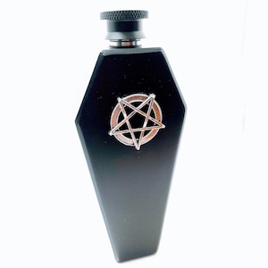Peut inclure: Une fiole noire en forme de cercueil avec un design de pentagramme argenté.