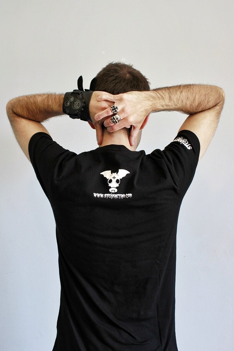 May include: Black t-shirt with a white graphic of a bat with a gas mask and the text "www.stemmetro.com".