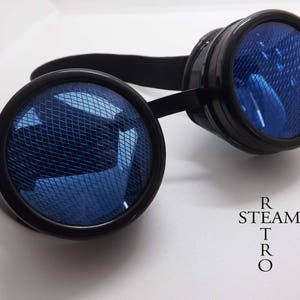 May include: Black steampunk goggles with round blue lenses featuring a mesh pattern. The lenses are set in black frames with a black headband.