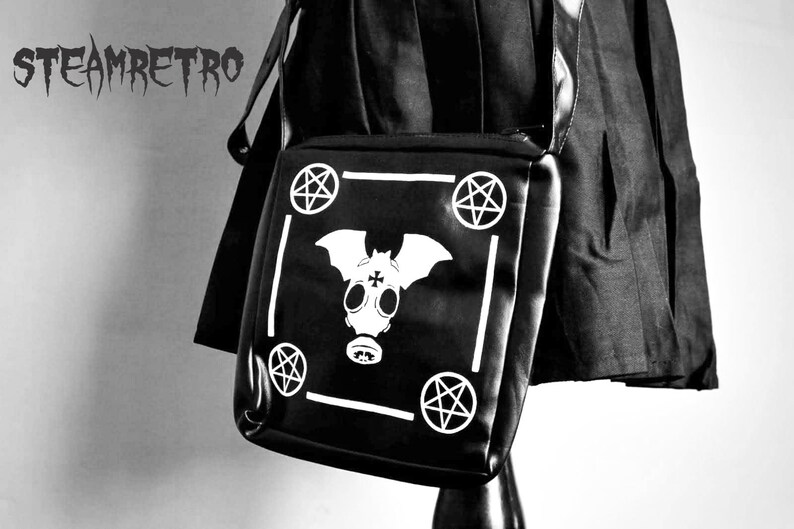 May include: Black shoulder bag with a white bat and pentagram design. The bag has a white border and the text "STEAMRETRO" is visible in the top left corner.