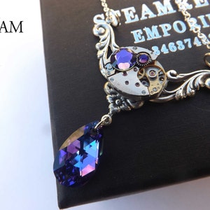 May include: A silver steampunk necklace with a purple crystal pendant and a vintage watch face with gears. The necklace is on a black background with the text "STEAM EMPORIUM 3468742518".