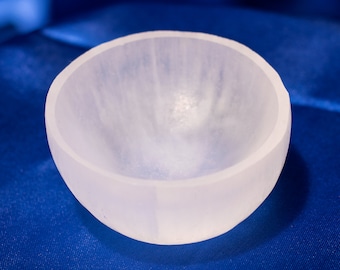 May include: A white selenite bowl, a smooth, polished, and translucent bowl made of selenite crystal.