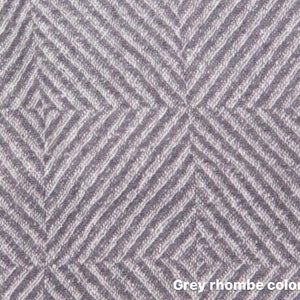 May include: A close-up of a grey fabric with a rhombus pattern. The fabric has a textured surface and a subtle sheen.