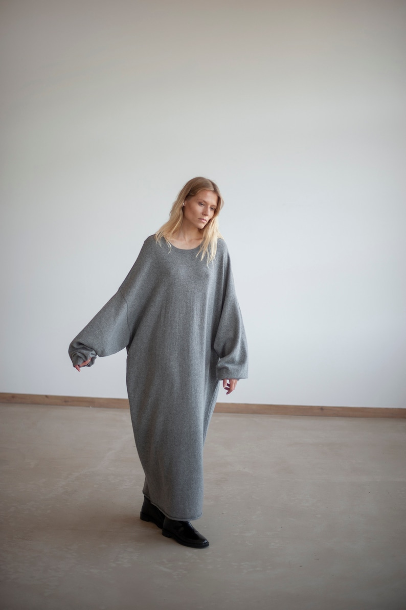 May include: A gray oversized sweater dress with long sleeves and a round neckline.