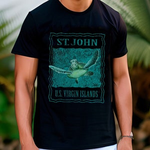 May include: Black t-shirt featuring a teal graphic of a sea turtle with the text "ST. JOHN U.S. VIRGIN ISLANDS". The design has a distressed, vintage look. The shirt is a crew neck and short-sleeved.