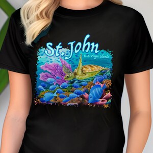 May include: Black t-shirt with a colorful graphic of a sea turtle swimming over coral and fish. The text "St. John U.S. Virgin Islands" is printed on the shirt.
