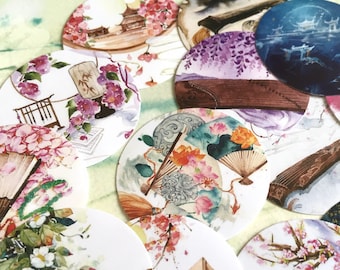 May include: A set of 10 round stickers featuring watercolor illustrations of traditional Japanese themes. The stickers depict scenes of cherry blossoms, wisteria, fans, and musical instruments. The stickers are perfect for adding a touch of Asian art to journals, planners, and other craft projects.