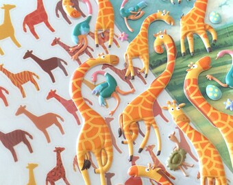 May include: A sheet of colorful, 3D giraffe stickers. The giraffes are in various poses and have orange and brown spots. There are also some blue and green bird stickers.