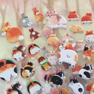 May include: A collection of colorful animal stickers featuring various breeds of dogs and rabbits. The stickers are designed with a cartoon-like style and feature the animals' rear ends.