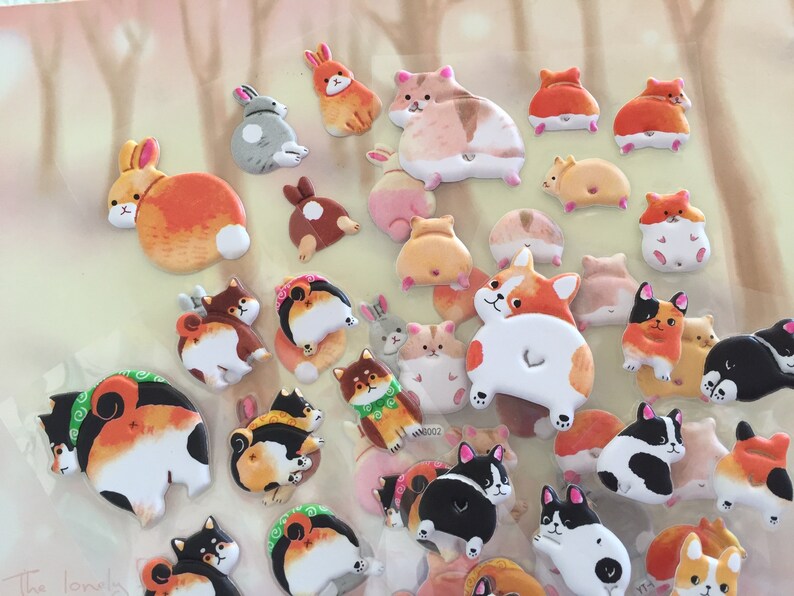 May include: A collection of colorful animal stickers featuring various breeds of dogs and rabbits. The stickers are designed with a cartoon-like style and feature the animals' rear ends.