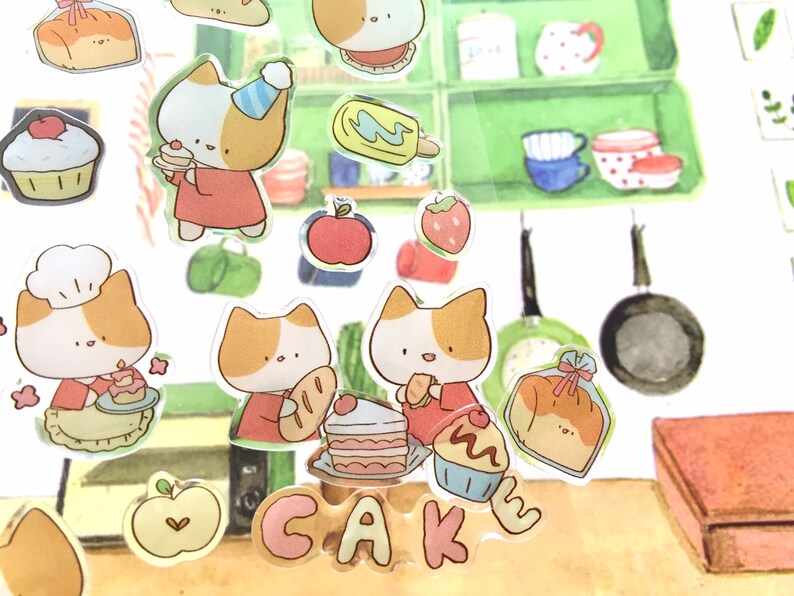 K&ouml;nnte beinhalten: Ein Set bunter Sticker mit niedlichen Katzen, Kuchen und anderen s&uuml;&szlig;en Leckereien. Die Sticker sind perfekt, um Ihrem Planer, Tagebuch oder Sammelalbum einen Hauch von Verspieltheit zu verleihen.