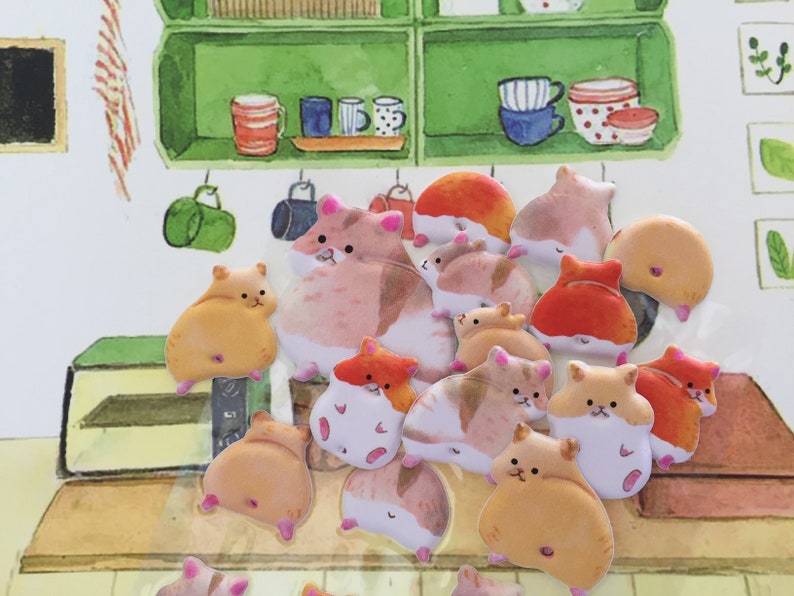 May include: A collection of colorful, cartoon hamster stickers. The hamsters are in various poses, including sitting, standing, and running. The stickers are perfect for adding a touch of whimsy to any project.