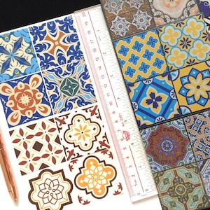 May include: A sheet of colorful patterned tile stickers. The stickers feature a variety of geometric designs in shades of blue, yellow, brown, and white. The stickers are arranged in a grid pattern on a white background.