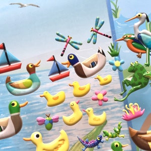 May include: A set of colorful, 3D foam stickers featuring ducks, dragonflies, frogs, and a sailboat. The stickers are perfect for adding a whimsical touch to any craft project.