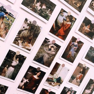 May include: A wall display of framed art prints featuring paintings of women in various poses and settings. The prints are arranged in a grid pattern and are held in place with small, round magnets.