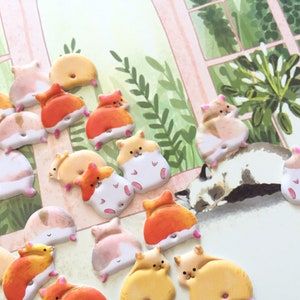 May include: A collection of 18 colorful, 3D hamster stickers with various poses. The stickers are made of a soft, foam-like material and have a glossy finish. They are perfect for adding a touch of whimsy to any project.
