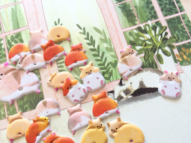 May include: A collection of 18 colorful, 3D hamster stickers with various poses. The stickers are made of a soft, foam-like material and have a glossy finish. They are perfect for adding a touch of whimsy to any project.
