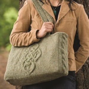 May include: A green knitted tote bag with a large Celtic knot design. The bag has a thick, braided strap.