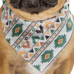 May include: A brown and white French Bulldog wearing a white bandana with a geometric pattern in shades of green, orange, and brown.
