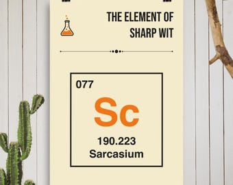 May include: A poster with the text "THE ELEMENT OF SHARP WIT" and a graphic of a flask. Below, a periodic table-style box reads "077 Sc 190.223 Sarcasium" in orange and black. The poster is held by clips against a white wood background.
