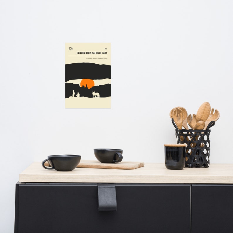 Może przedstawiać: Minimalistyczny plakat z czarno-białą ilustracją zachodu słońca nad kanionem. Tekst "CANYONLANDS NATIONAL PARK" jest wydrukowany na g&oacute;rze plakatu czarnym kolorem.