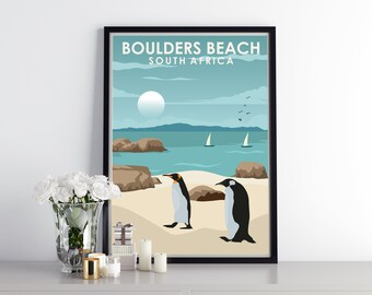 May include: A retro-style poster with the text "Boulders Beach, South Africa" and an illustration of two penguins on a beach with sailboats in the distance.