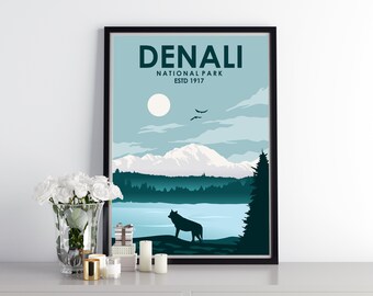 May include: A framed poster with a blue and green landscape design. The poster features a mountain range, a lake, a wolf, and the text "DENALI NATIONAL PARK ESTD 1917".