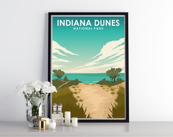 May include: A black framed poster with a retro design featuring a scenic view of Indiana Dunes National Park. The poster depicts a sandy path leading to a turquoise blue lake with a cloudy sky and green trees.