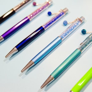 Crystal Ballpoint Pen with Dangling charms Filled With Swarovski Crystal Elements.