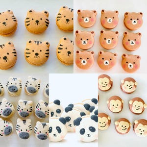 May include: An assortment of animal-themed macarons, including tigers, bears, zebras, pandas, and monkeys. The macarons are in various colors, with detailed facial features. The baked goods are arranged on a white surface, showcasing the variety of designs.