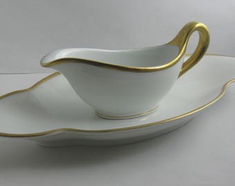 Rosenthal Selb-Bavaria. Age old porcelain. Mini sauce boat on small, curved bowl. Ivory colored with thick gold borders. VINTAGE