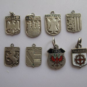 ONE of 5: SMALL coat of arms pendants for charm bracelet. Silver (WITHOUT hallmark) and partly enamel. Vintage Souvenir