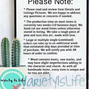 May include: A white sign with black text that reads "Please Note:" and lists details about production time, shipping, and the handmade nature of the items. The text includes information about the use of wood and potential imperfections. The sign is displayed against a light brown background.
