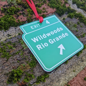 May include: Green and white exit sign with the text "Exit 4 Wildwoods Rio Grande" and an arrow pointing upwards.