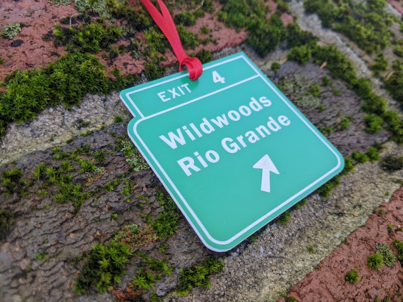 May include: Green and white exit sign with the text "Exit 4 Wildwoods Rio Grande" and an arrow pointing upwards.