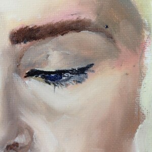 May include: Close-up of a woman's eye with dark brown eyebrows and a hint of pink eyeshadow. The eye is closed, and the eyelashes are visible. The skin is smooth and pale.