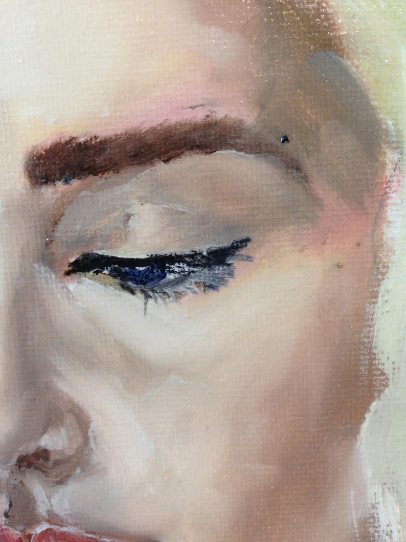 May include: Close-up of a woman's eye with dark brown eyebrows and a hint of pink eyeshadow. The eye is closed, and the eyelashes are visible. The skin is smooth and pale.