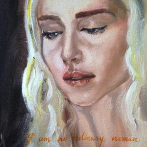 May include: A painting of a woman with long blonde hair. She is looking down with a sad expression. The text "I am no ordinary woman. My dreams come true." is written in gold lettering on the bottom of the painting.