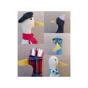 May include: Five plush toy ducks with different accessories. One duck is wearing a beret, another a party hat, another a crown, another glasses, and the last a scarf.