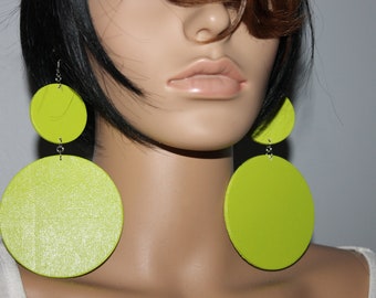 May include: A pair of large, round, lime green earrings. The earrings are made of wood and have a shiny finish.
